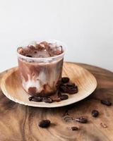 Ice chocolate drink with foam and cacao beans