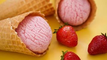 Strawberry ice cream in a waffle cone. Ice cream photo