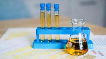 Flask and test tubes with urine on medical color schemes photo