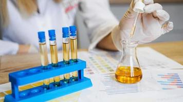 Woman making urine test with ph material in laboratory photo