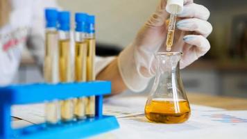 Woman making urine test with ph material in laboratory photo