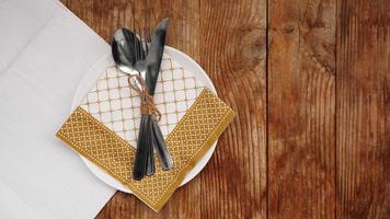 Place setting for dinner on rustic background. Top view. Copy space. photo