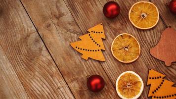 Dry oranges, red balls and wooden christmas figurines photo