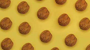 Walnuts lie in rows on yellow cardboard. Top view photo