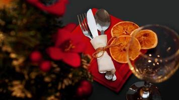 Setting for festive Christmas dinner on black table with decoration photo