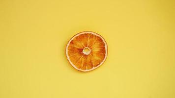 Dried orange on a yellow background. photo