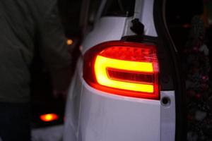 Closeup of car tail light on a white car. photo