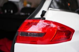 White car with headlight and open door photo