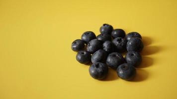 Delicious fresh blueberry on yellow background photo