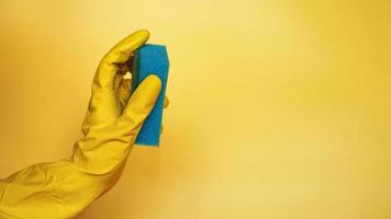 Sponge for washing dishes in hand. Hand in a latex photo