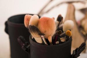 Makeup brushes in a makeup artist case on blurred background photo