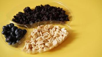 Berries ad nuts in plastic container for food storage photo