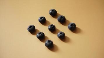 Blueberries are laid out in rows on a gold background photo