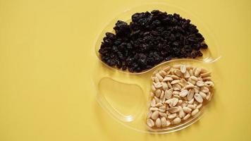 Dry fruits and nuts in plastic container for food storage photo