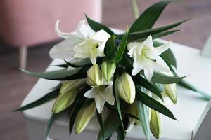 Lily bouquet on the background of white-pink interior photo