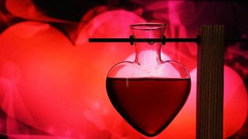 Open heart-shaped bottle of red love potion on a blurred background photo