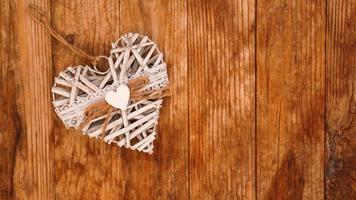 White hand made heart on wooden background photo