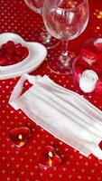 Valentines day concept table. romantic dinner with medical mask photo