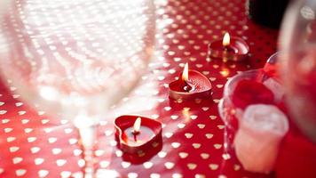 Candles for valentines day, table with festive red background