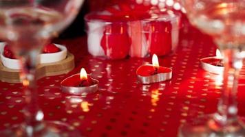 Candles for valentines day, table with festive red background photo