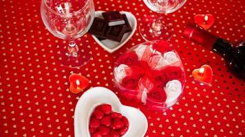 Valentines day. Bottle of vine, glasses, red roses photo