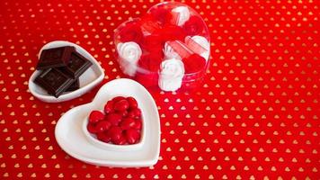 Chocolate candies in heart shaped plate