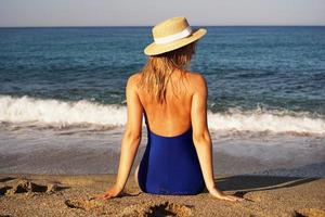 Young Woman Sunbathing At Tropical Beach photo