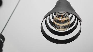 A modern loft chandelier made of black metal spiral photo