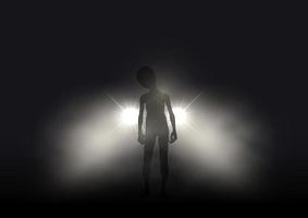 Silhouette of an alien lit up in car headlights on foggy night vector