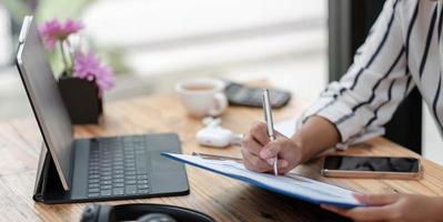 Woman working business paperwork on desk office photo