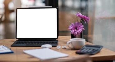 Computer laptop with blank screen on table of coffee shop photo