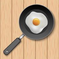 Fried egg with cooking pan on wooden table vector