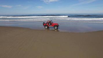 Aerial shot of 4x4 off road vehicle driving on beach video