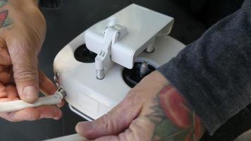 Man preparing remote control for drone video