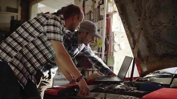 Two Mechanics in Garage Repairing a Car video