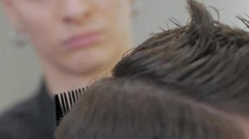 Cerca del hombre cortándose el pelo en la peluquería video