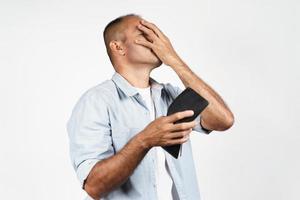 Man holding his empty wallet on white background. no money. photo