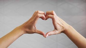 Female hands folded in the shape of a heart photo