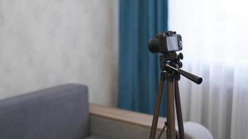 Camera on a tripod indoors. Filming a video blog photo