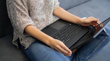 Woman using laptop with blank screen photo