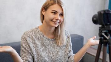 Cheerful female blogger recording video photo