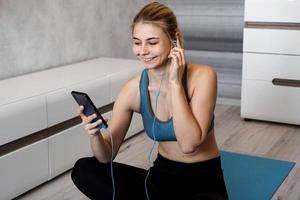 Sport woman with earphones enjoying the music playing