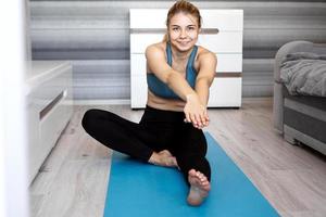 Sport, training and lifestyle concept - woman stretching photo