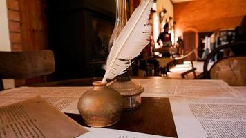 White quill and inkwell in the old university auditorium photo