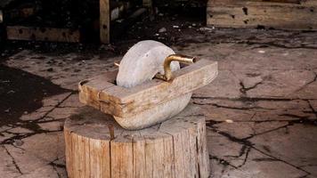 An old grinder in an authentic smithy. Weapon making in ancient times. photo