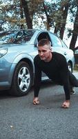 Handsome man near the car. The athlete wrung out next to the machine photo