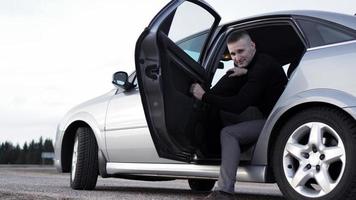 Handsome man near the car. Luxury life. photo