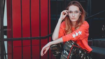 Fashion model wearing red hoodie with inscription los angeles photo