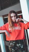 Fashion model wearing red hoodie with inscription los angeles photo