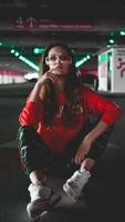 Pretty young woman sitting on car parking photo